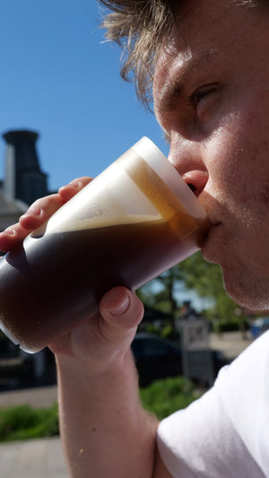guy using komfid lid to drink a drink with