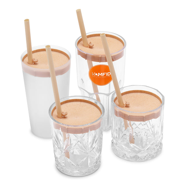 Clear plastic cups with wooden lids and straws on a white background